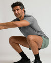 Man demonstrating squat in 7 Juniper Active Training Shorts 2.0.