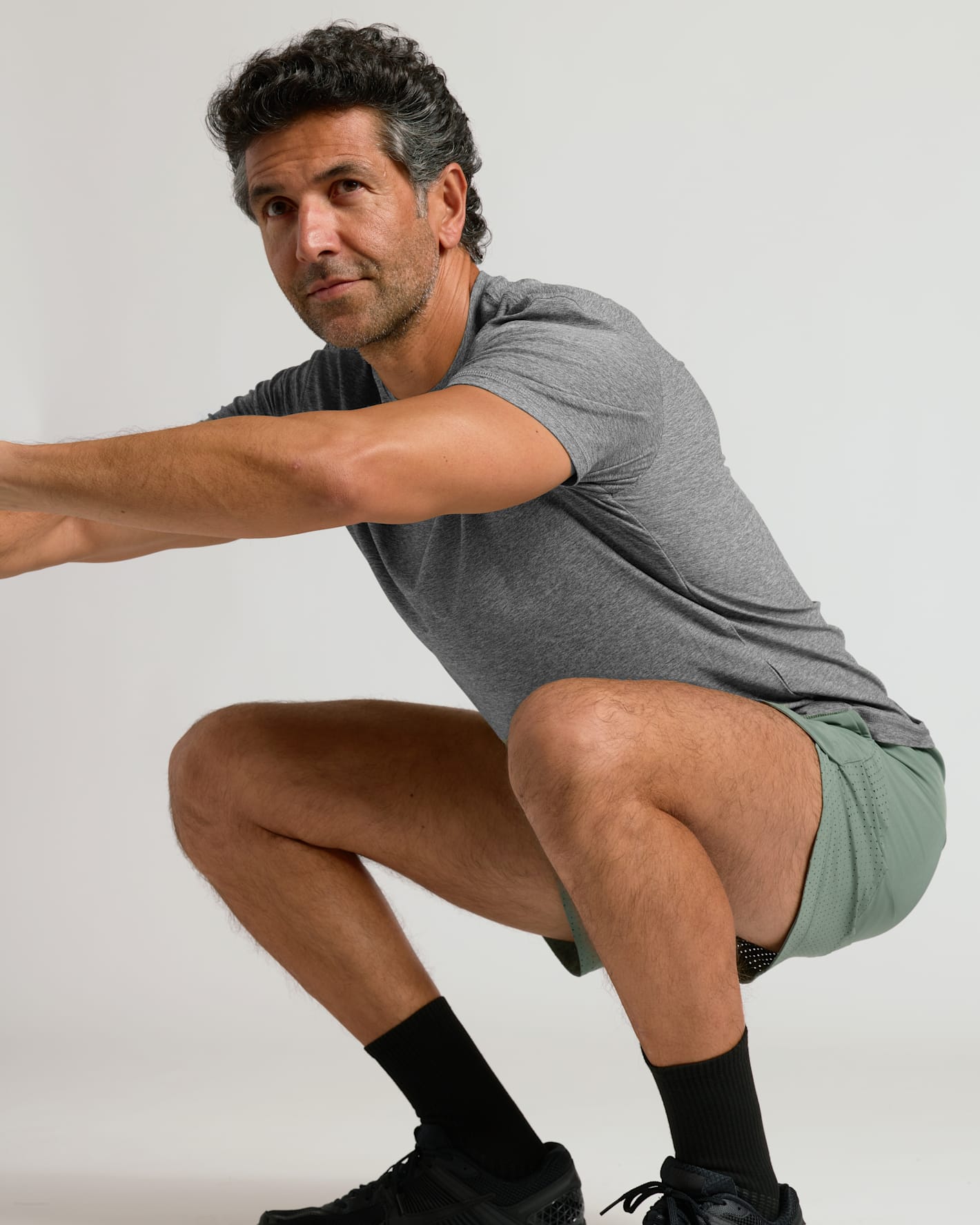Man demonstrating squat in 7 Juniper Active Training Shorts 2.0.