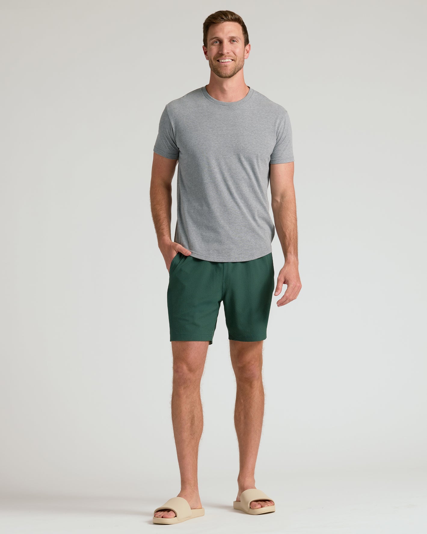 Man wearing 7 Marine Spruce Seersucker Swim Trunks with sandals.