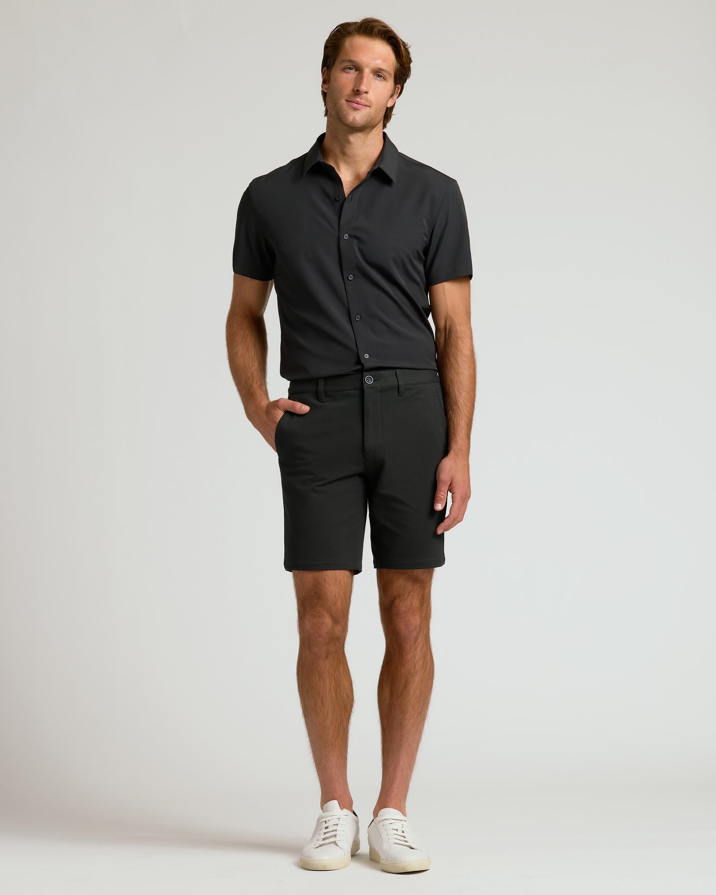 Man wearing 9 Black Chino Shorts 2.0 with white sneakers.
