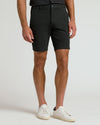 Man wearing 9 Black & Khaki Chino Shorts 2-Pack with white sneakers.