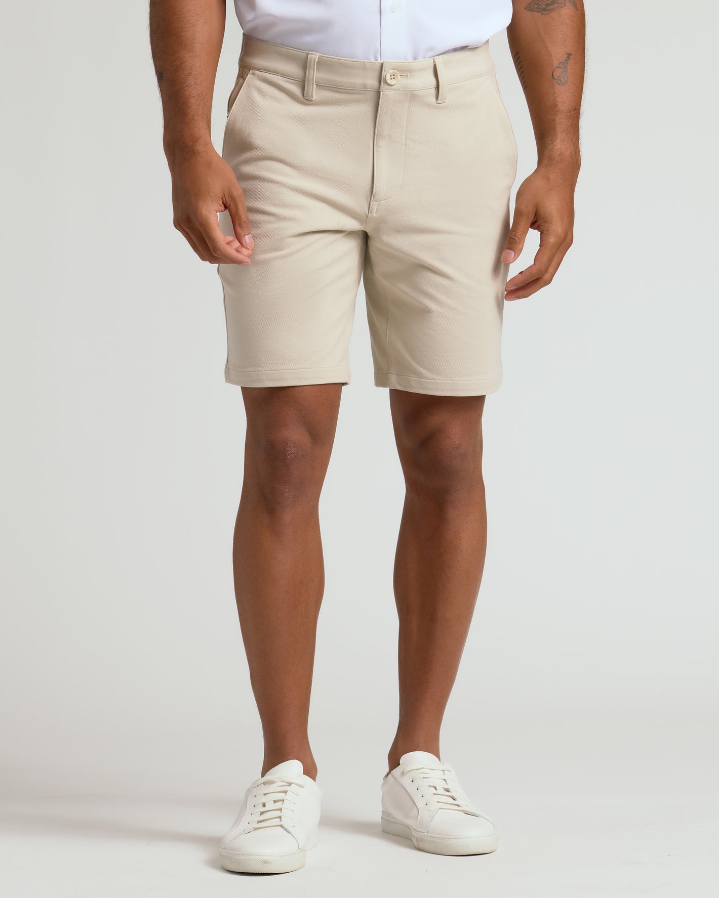 Person wearing 9 Sandstone Chino Shorts with white sneakers.