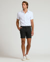 Man wearing 7 Black Chino Shorts 2.0 with white shirt.