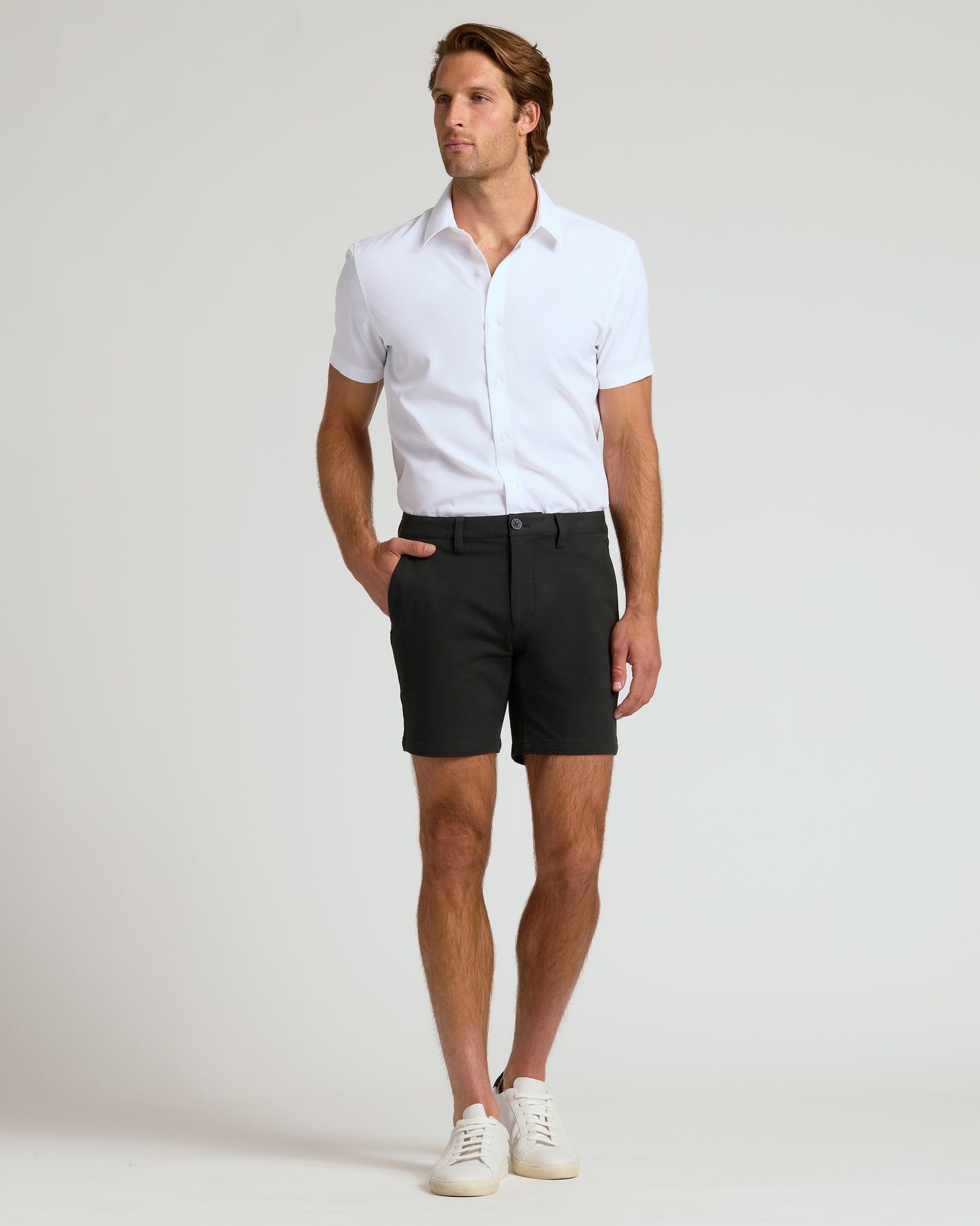 Man wearing 7 Black Chino Shorts 2.0 with white shirt.