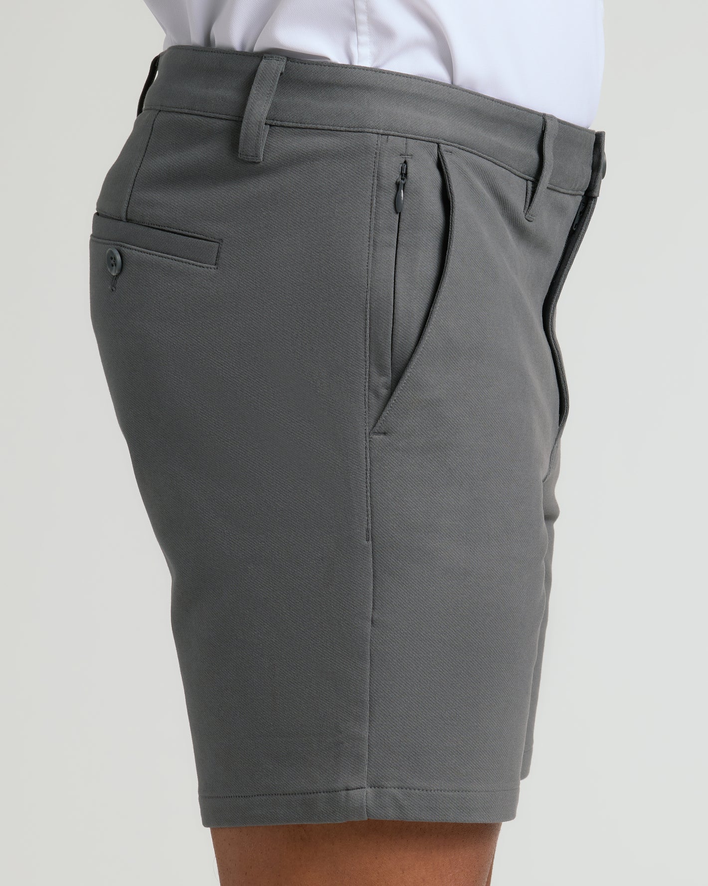 7 Carbon Chino Shorts 2.0, tailored mid-thigh, with zippered and buttoned pockets.