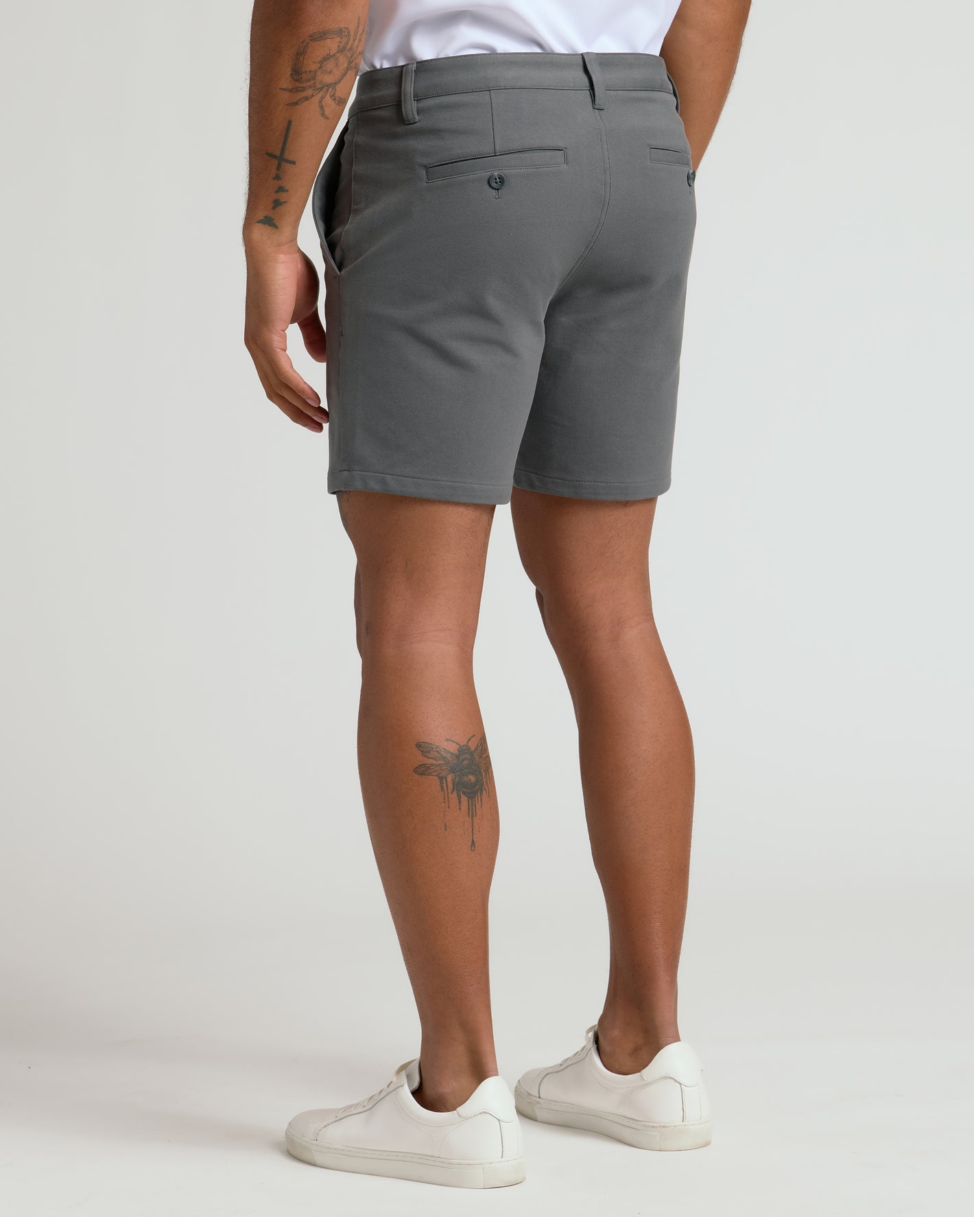 Back view of 7 Carbon Chino Shorts 2.0 with tattoos on legs.