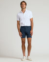 Man wearing 7 Navy Chino Shorts 2.0 with white shirt.