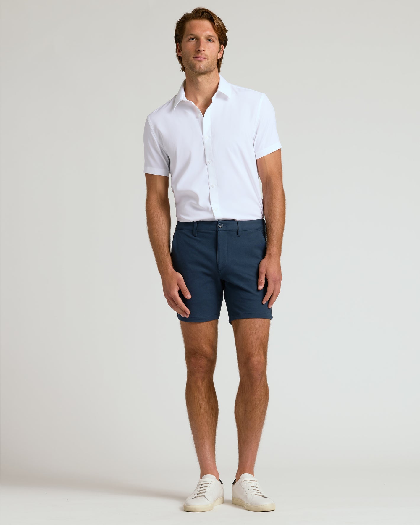 Man wearing 7 Navy Chino Shorts 2.0 with white shirt.