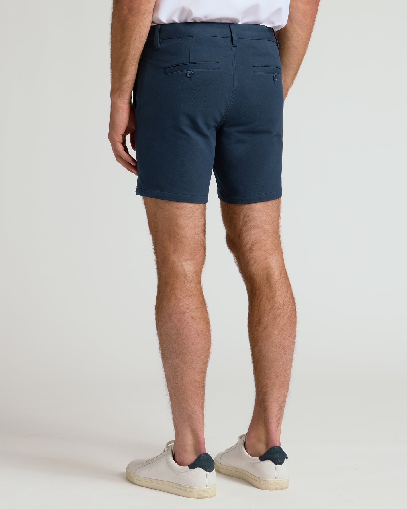 7 Navy Chino Shorts 2.0, fitted, mid-thigh, with buttoned back pockets.