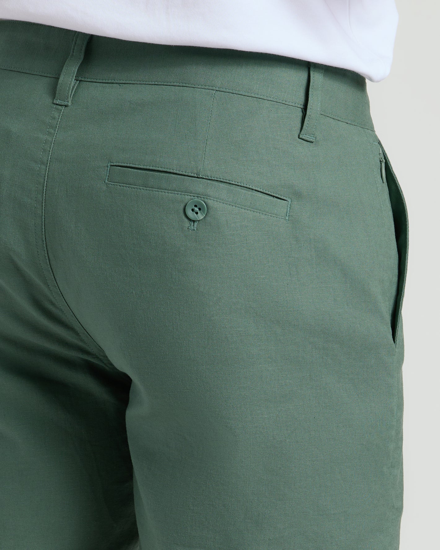 7 Moss Linen Shorts, rear view with buttoned back welt pocket.