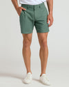 Man wearing 7 Moss Linen Shorts with side pockets and white sneakers.