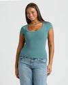 Woman in Womens Stormcloud Ribbed U-Neck Tee and relaxed jeans.