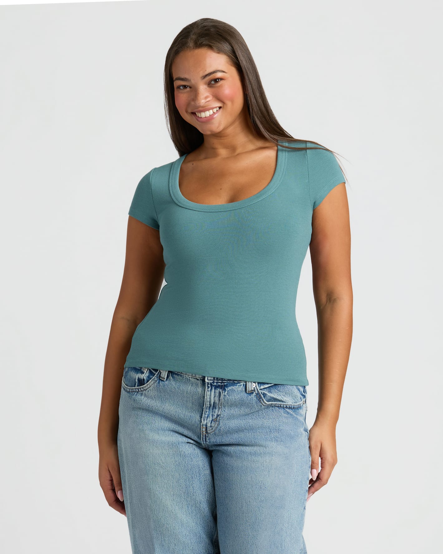 Woman in Womens Stormcloud Ribbed U-Neck Tee and relaxed jeans.