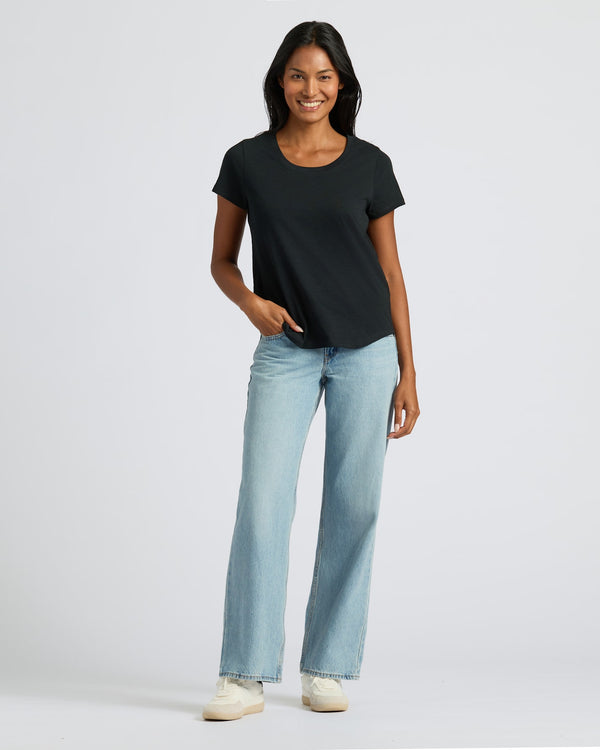 Woman in black Relaxed Slub Tee and jeans.