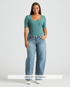Woman in teal Womens Stormcloud Ribbed 3/4 Sleeve Scoop Neck Tee, jeans, sneakers.