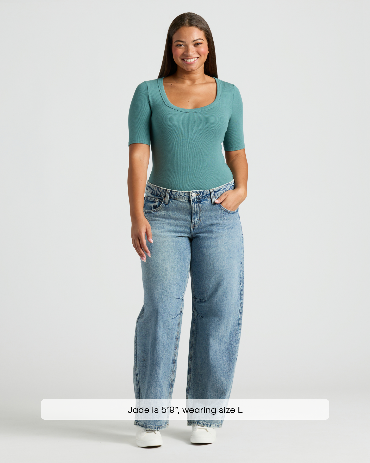 Woman in teal Womens Stormcloud Ribbed 3/4 Sleeve Scoop Neck Tee, jeans, sneakers.