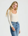 Woman in Womens Ribbed Long Sleeve Scoop Neck Tee, smiling in light-wash jeans.