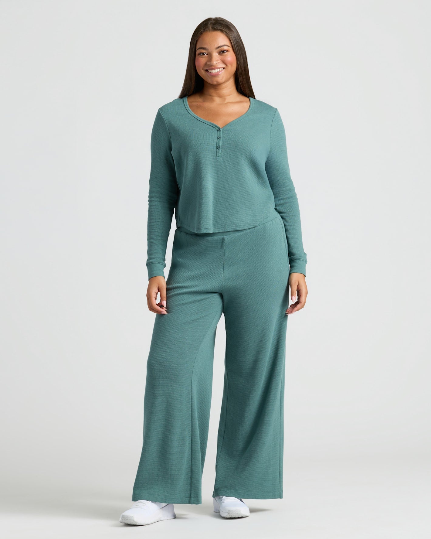 Woman wearing Womens Stormcloud Waffle Long Sleeve Boxy Henley with matching pants.