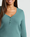 Woman in teal-green Womens Stormcloud Waffle Long Sleeve Henley top, smiling.