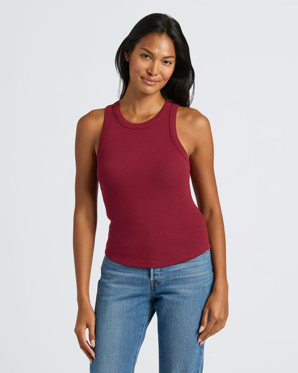 Womens Dark Maroon Ribbed High Neck Tank with mid-wash blue jeans. MODEL_INFO: Candy is 5'9", wearing a size S