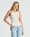 Woman in cream Womens Ribbed High Neck Tank 3-Pack, smiling confidently.