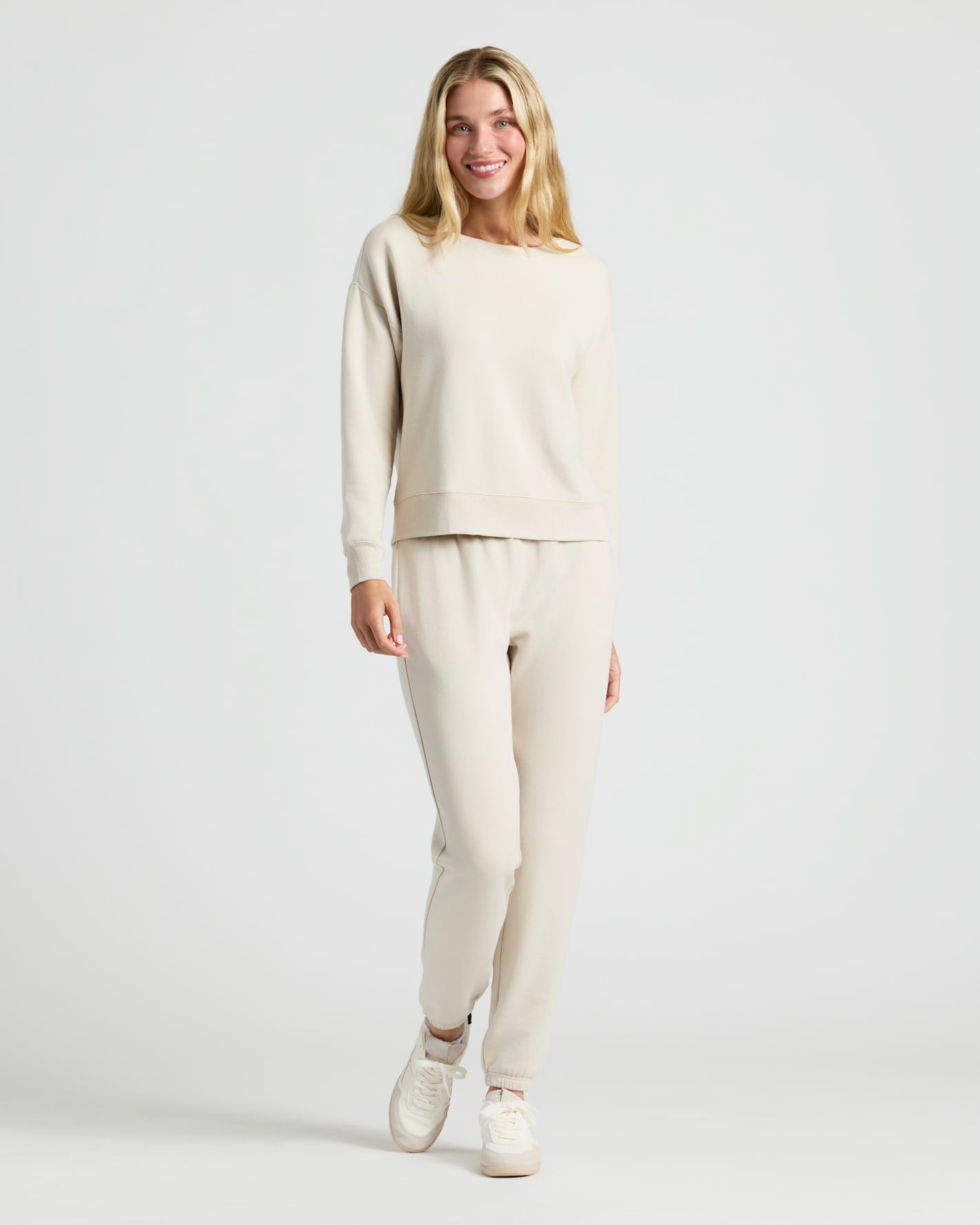 Woman wearing Womens Oatmeal Slouch Pullover Crew and jogger set.