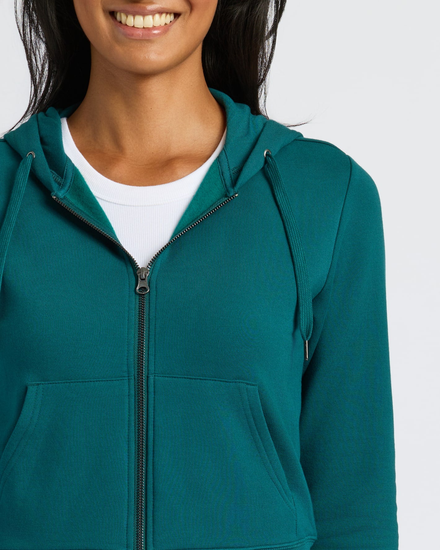 Womens Deep Emerald Crop Zip Hoodie, smiling model, partial face visible.