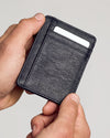 Black Classic Wallet held in hands, showcasing pebbled texture and TRUE CLASSIC embossing.