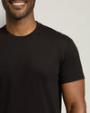 Man wearing a black t-shirt against a plain background