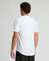 Man wearing a white t-shirt on a plain background