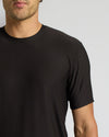 Black t-shirt worn by a person on a plain background