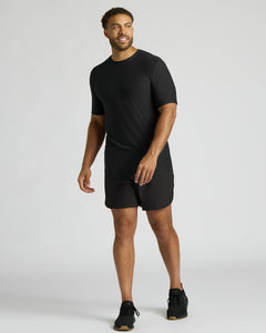 True ClassicMan wearing a black t-shirt and shorts on a white background