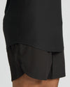 Black athletic shorts with a layered design on a white background