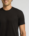Man wearing a black t-shirt against a plain background