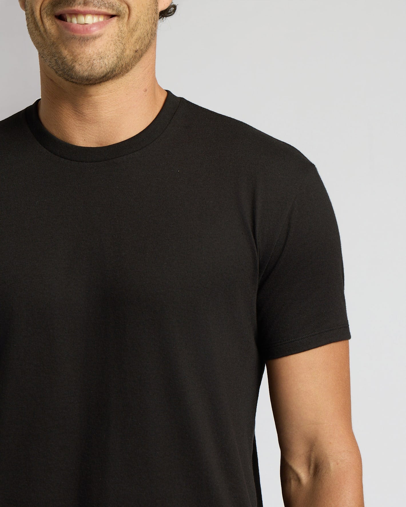Man wearing a black t-shirt against a plain background