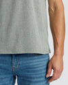 Person wearing a gray t-shirt and blue jeans on a white background