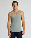 Man wearing a gray tank top against a plain background