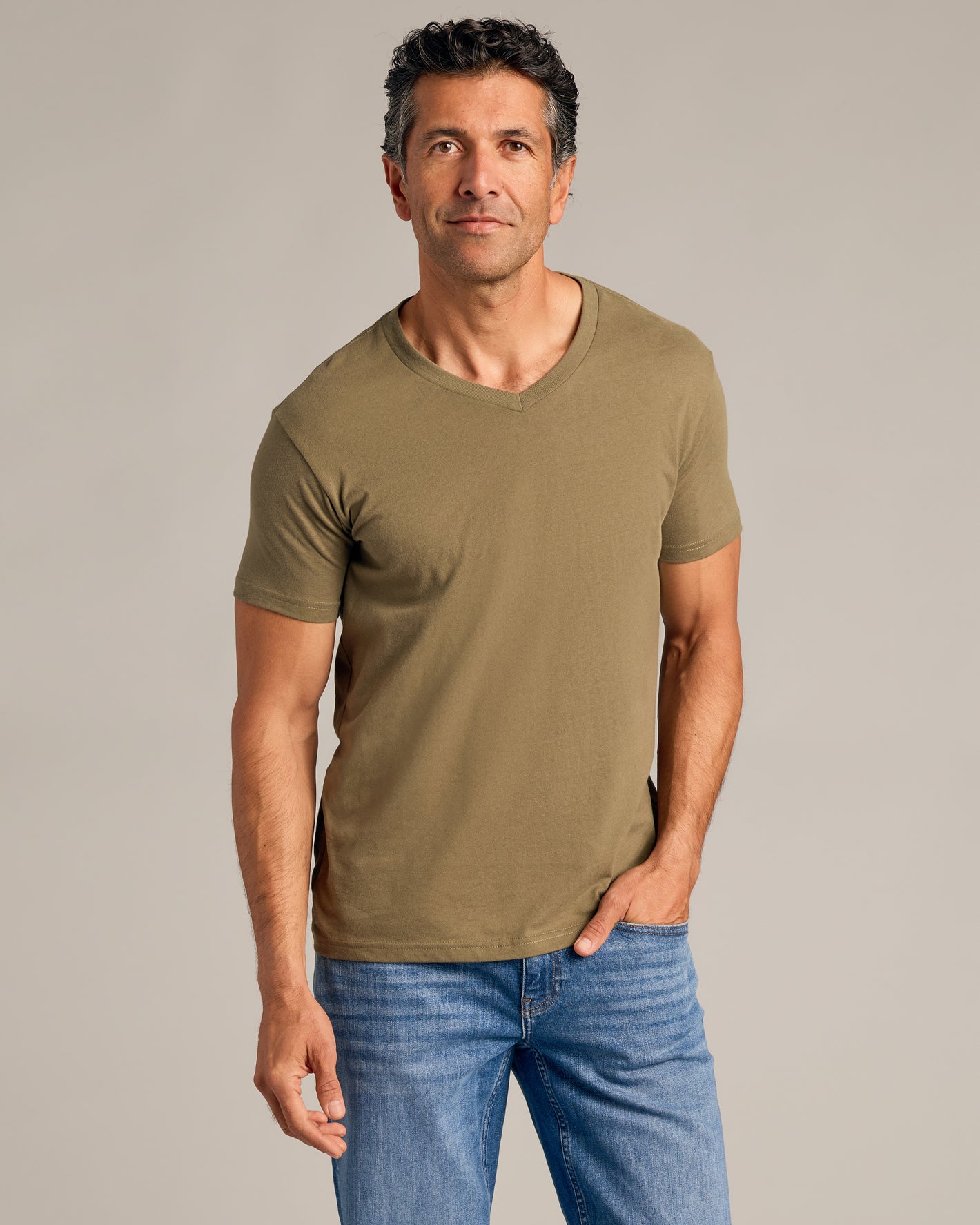 Man wearing Carbon Green Classic V-Neck, showcasing its fit and style.