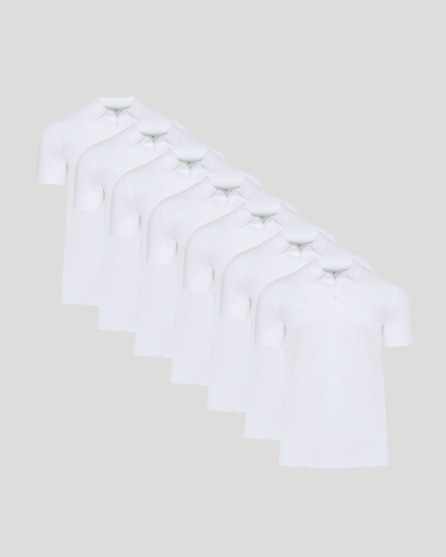 White Premium Pima Polo 7-Pack arranged staggered, showcasing sleek design.