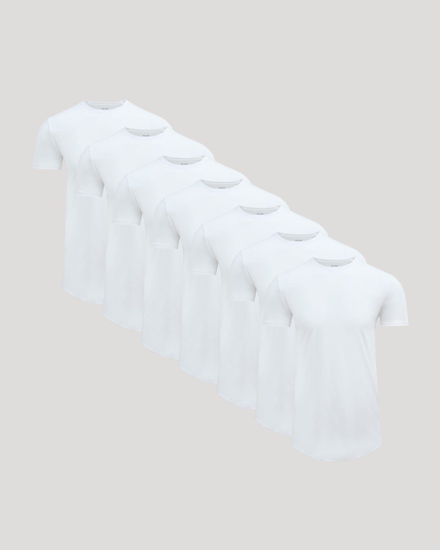 White Tall Premium Pima Crew Curved Hem 7-Pack fanned diagonally.