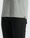 True Classic Men’s Classic Short Sleeve Polo Shirt over black pants.