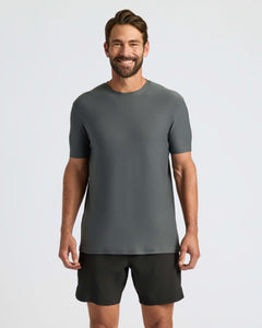True ClassicMan in Classic Polo, smiling, with dark gray T-shirt and black shorts.