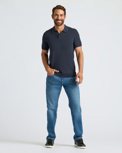 True ClassicMan wearing Navy Dressy Polo, blue jeans, black sneakers, smiling.