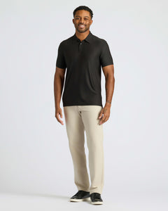 True ClassicMan models Black Active Polo 2.0 with beige trousers and black sneakers.