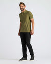 Man modeling Military Green Active Polo 2.0 with black slim-fit pants.