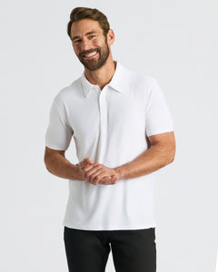 True ClassicMan wearing White Active Polo 2.0, smiling, hands clasped.