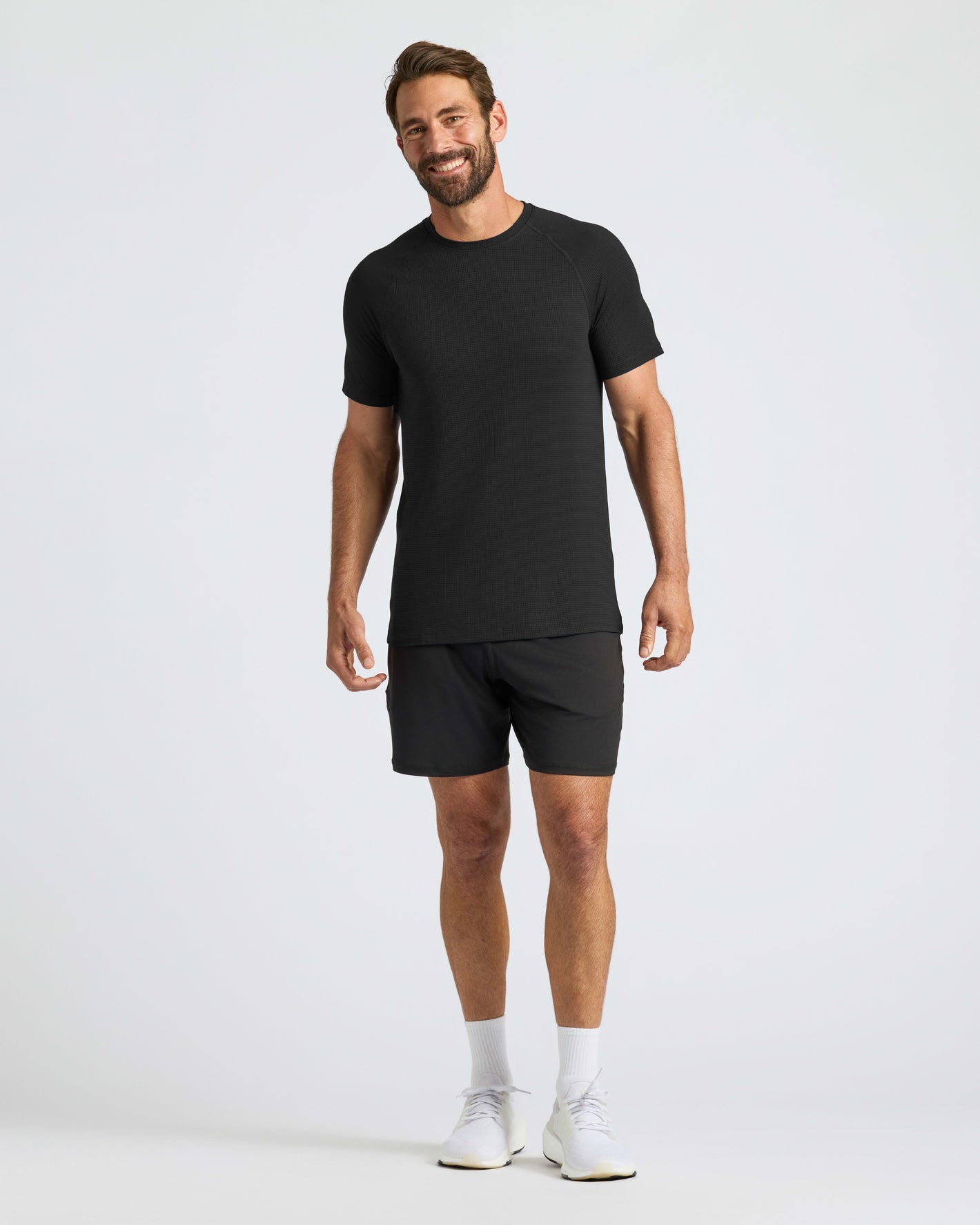 Man wearing Black Active Mesh Crew, showcasing athletic fit and mesh fabric.