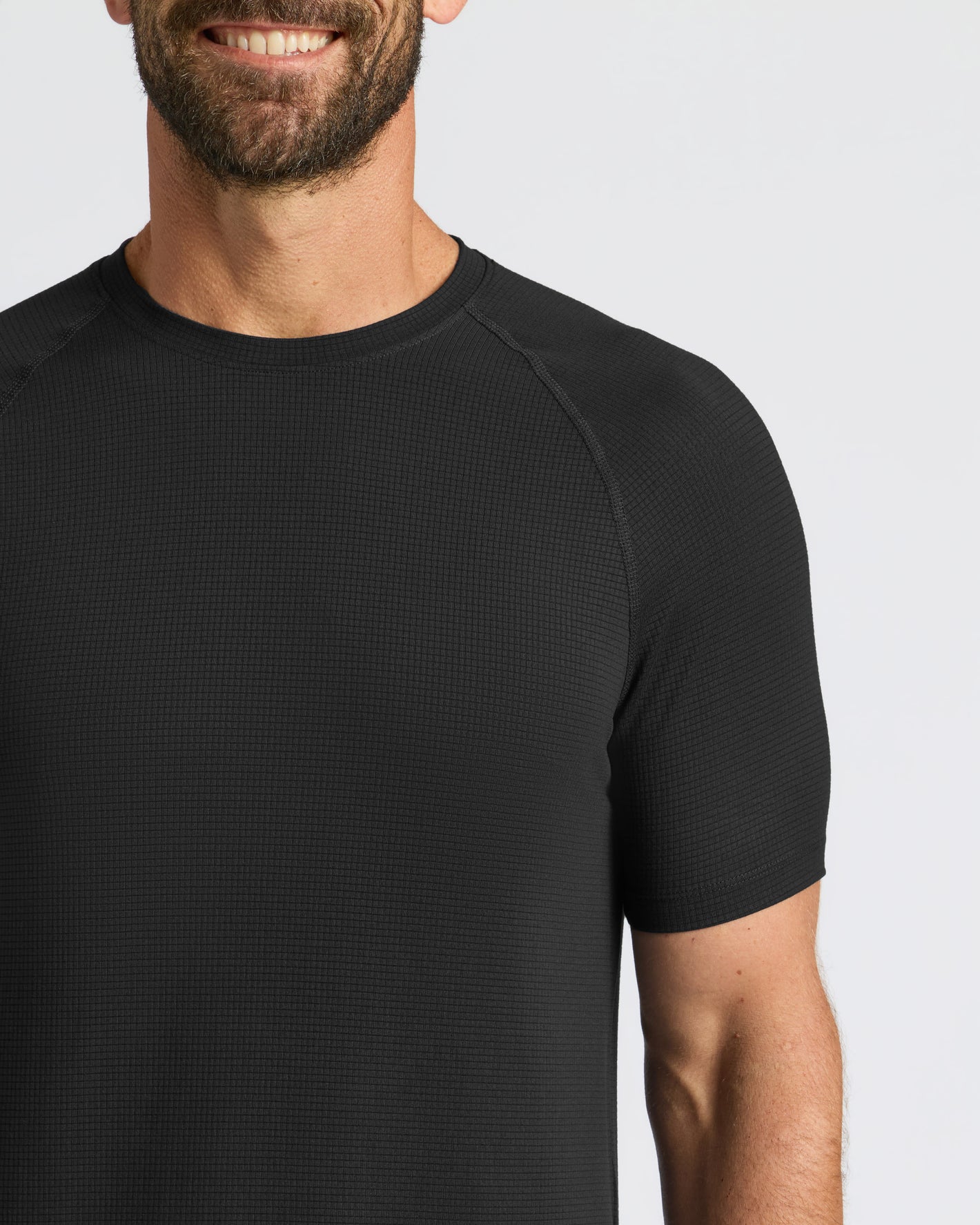 Man in Black Active Mesh Crew, textured pattern shirt.