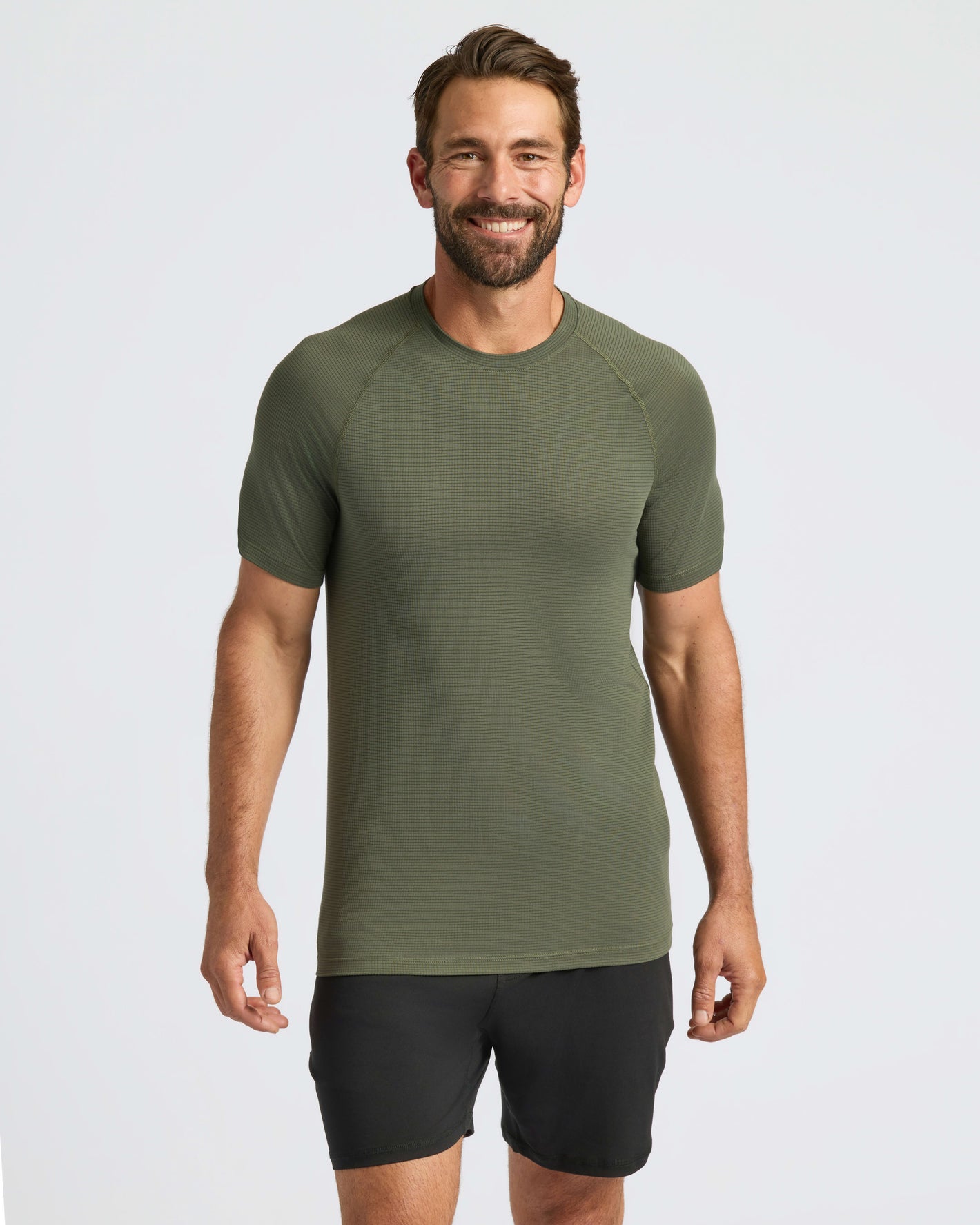 Man wearing Kelp Active Mesh Crew and black athletic shorts.