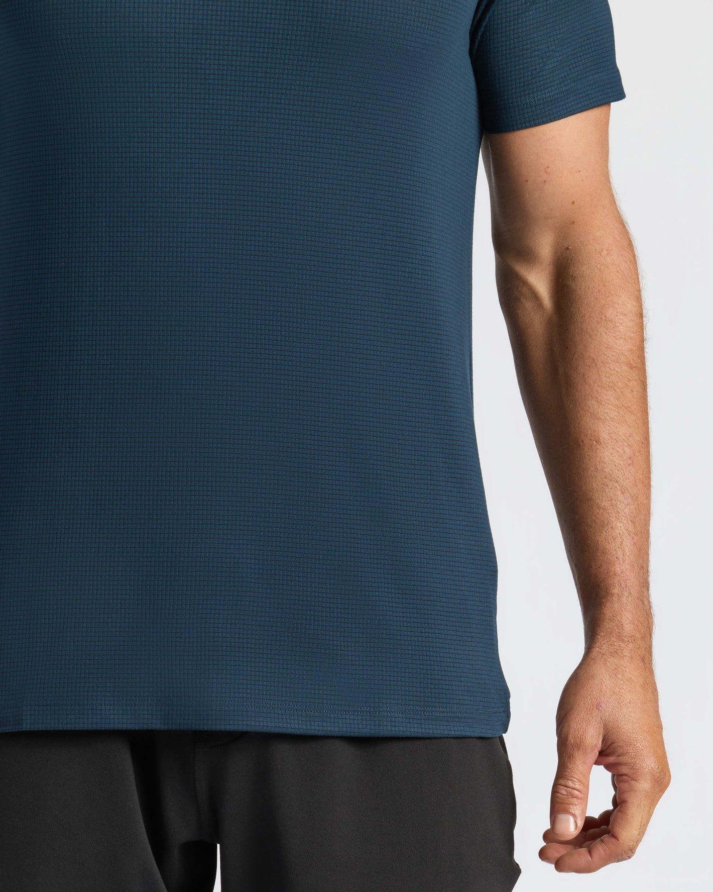 Person wearing Navy Active Mesh Crew, showing shirt's texture and fit.